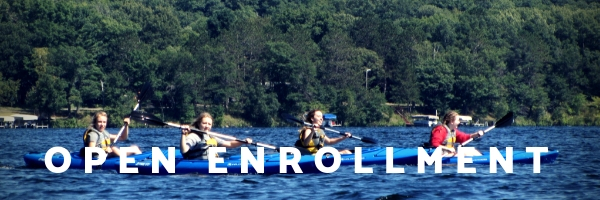 photo of kids kayaking that says "open enrollment"