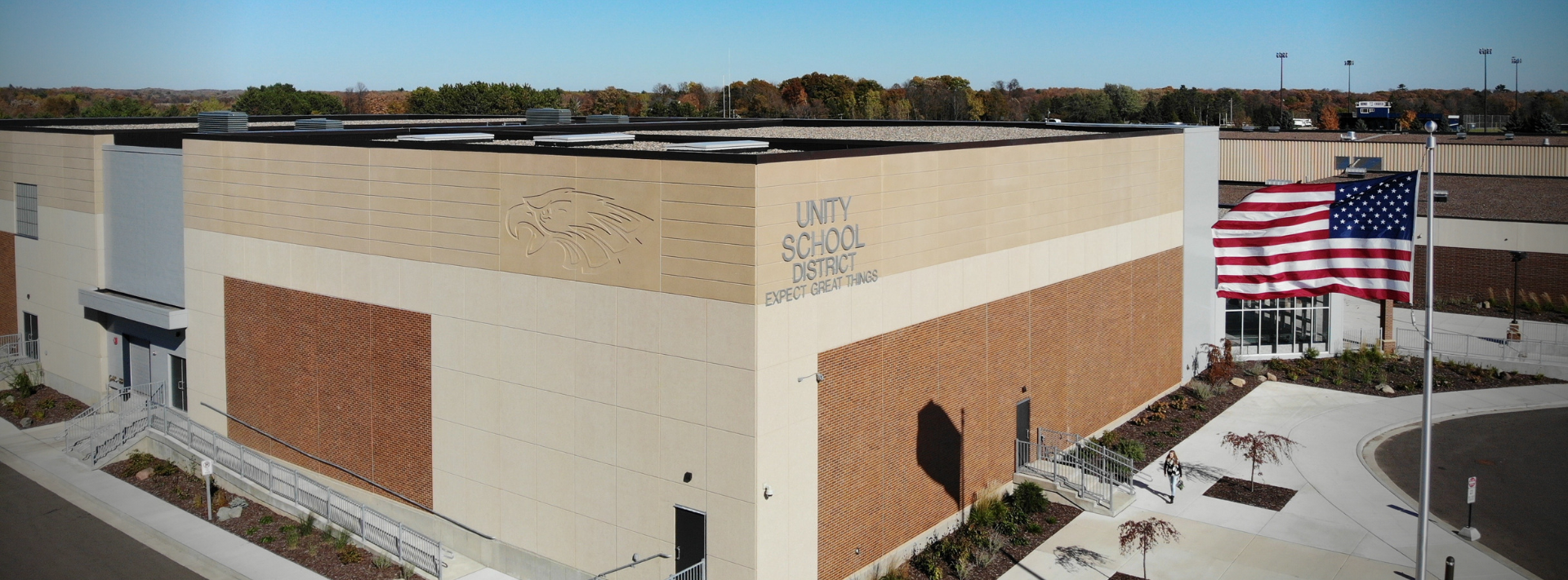 Exterior view of the Unity School District building with the school logo in the upper left corner.