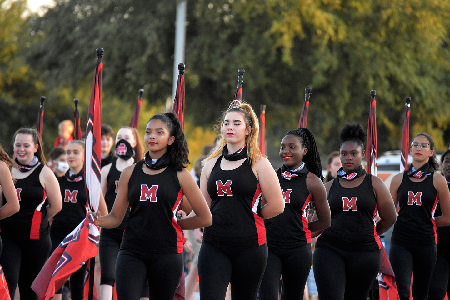 Colorguard students walk in the Homecoming Parade