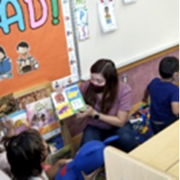 Teacher reading aloud to students.