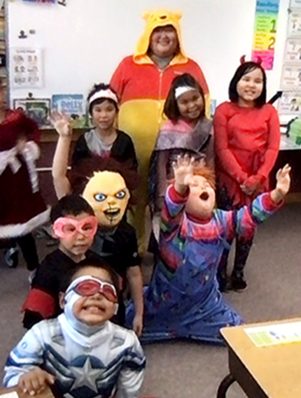 2nd graders and para wearing decorative masks.
