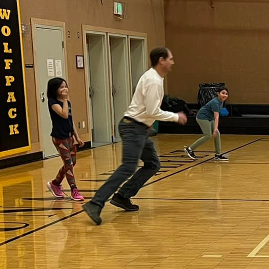 Kris Busk with students in gym