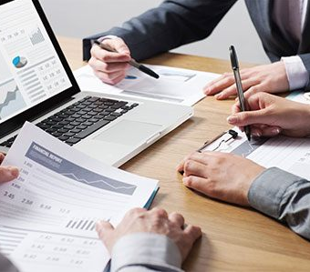 Hands, papers and laptop  from a business team