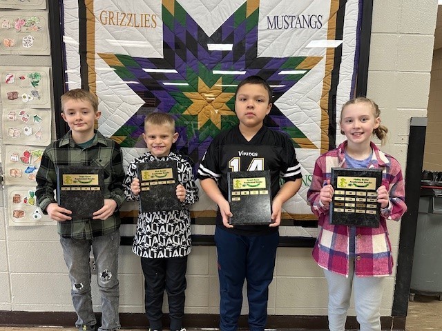 group of students holding awards