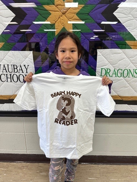 student holding t shirt