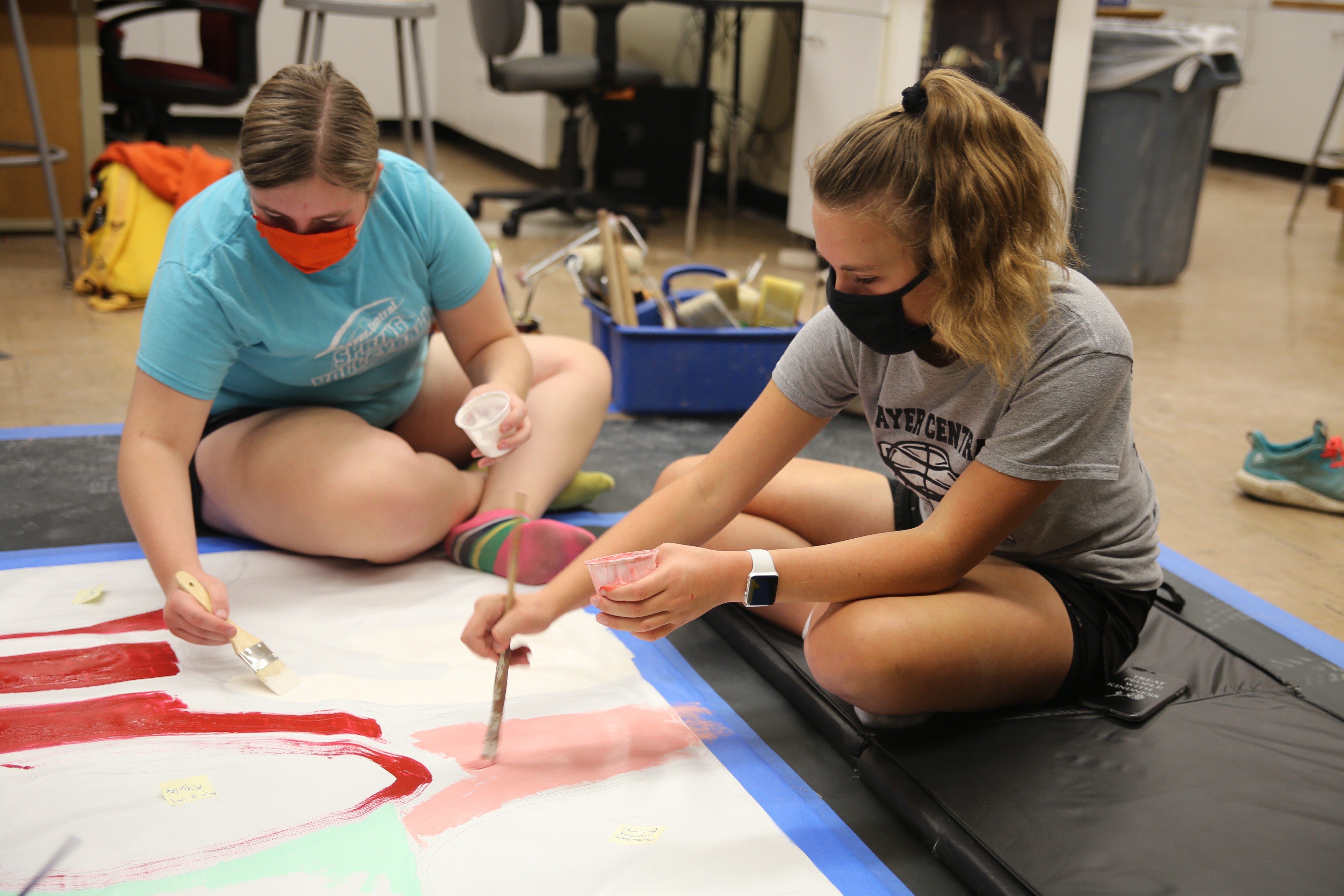 two students paint for the Hastings Mural Competition