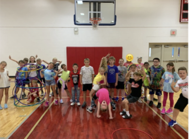 STUDENTS IN GYM with hula hoops