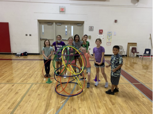 STUDENTS IN GYM with hula hoops