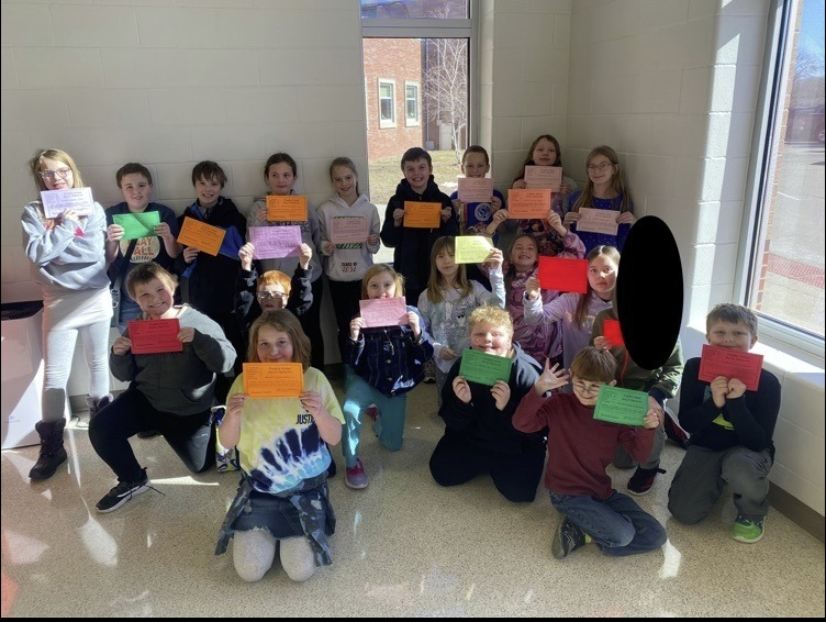 KIDS OF CHARACTER awards - kids standing in the lunch room holding awards 