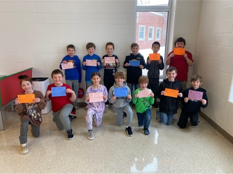 KIDS OF CHARACTER awards - kids standing in the lunch room holding awards 