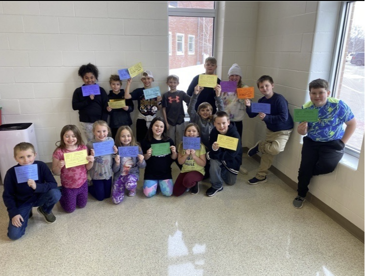 KIDS OF CHARACTER awards - kids standing in the lunch room holding awards 