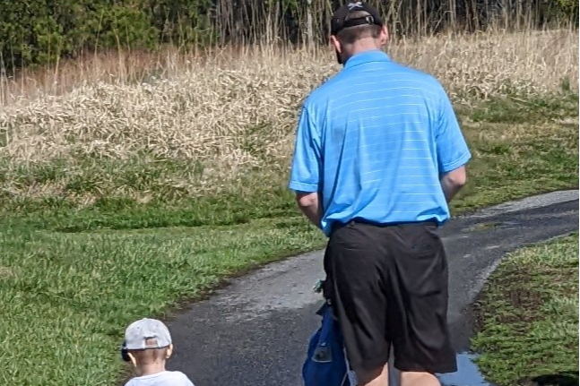 The guys walking the golf course.