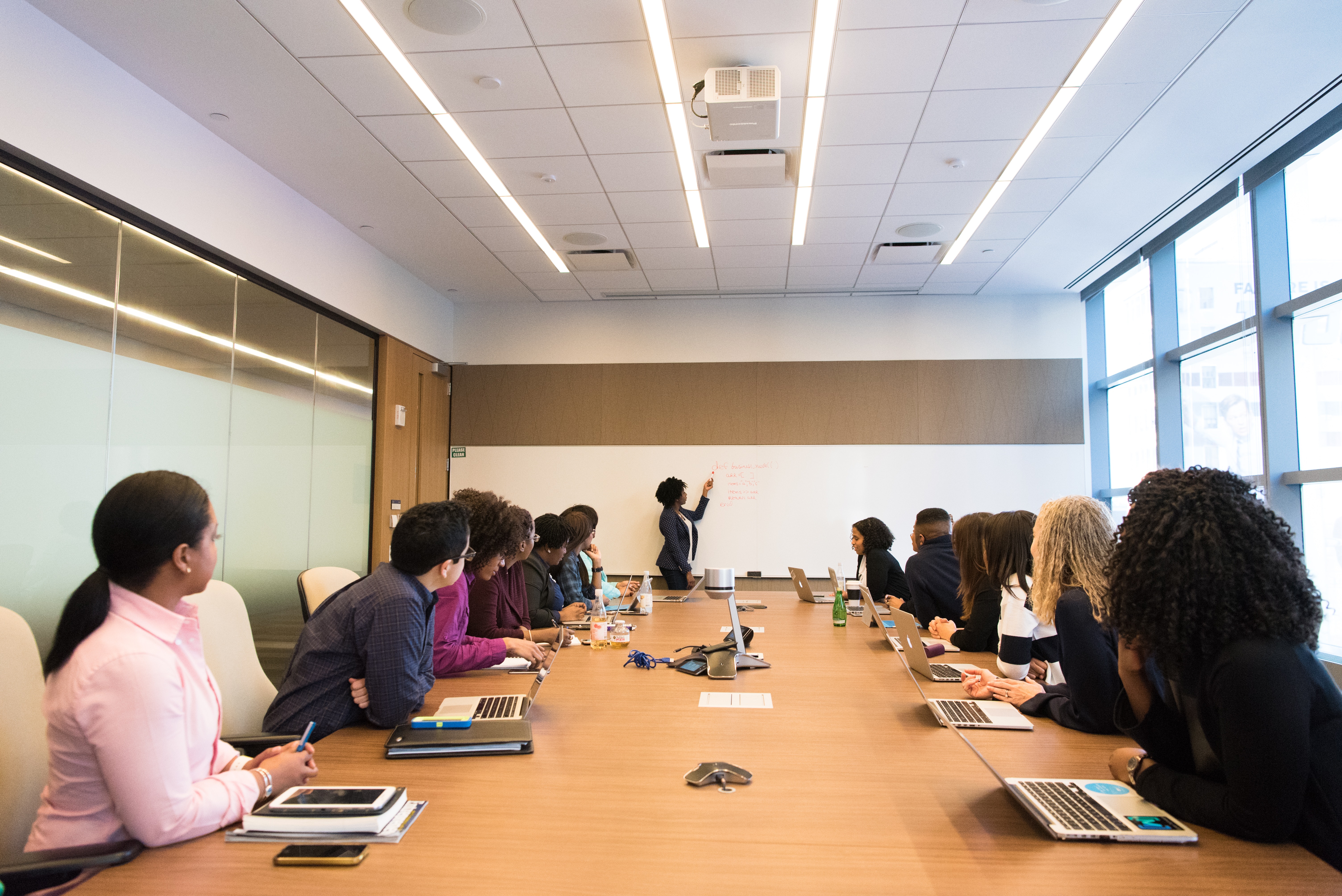 photo: professional development workshop with people sitting at a conference table