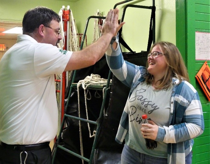 Teacher and student celebrates with a high five.