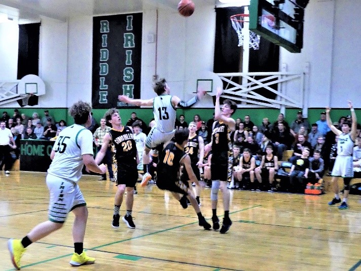 A Riddle basketball player goes up for a basket.