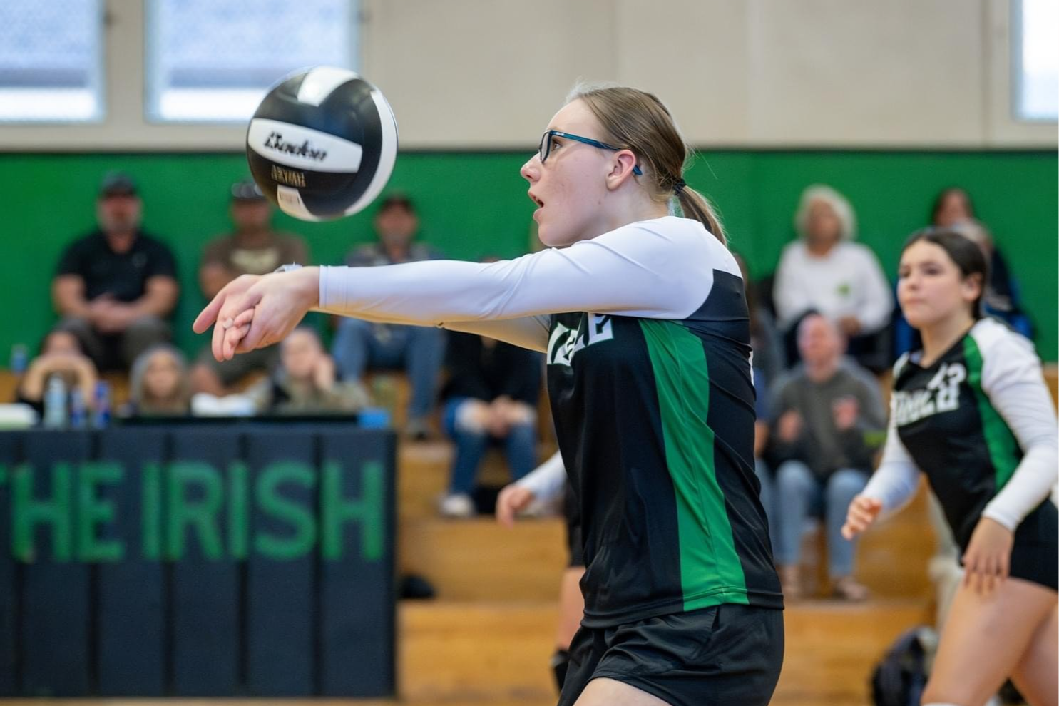 Junior High volleyball players return ball