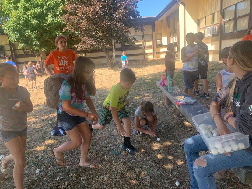 Campers participating in an egg activity outside.