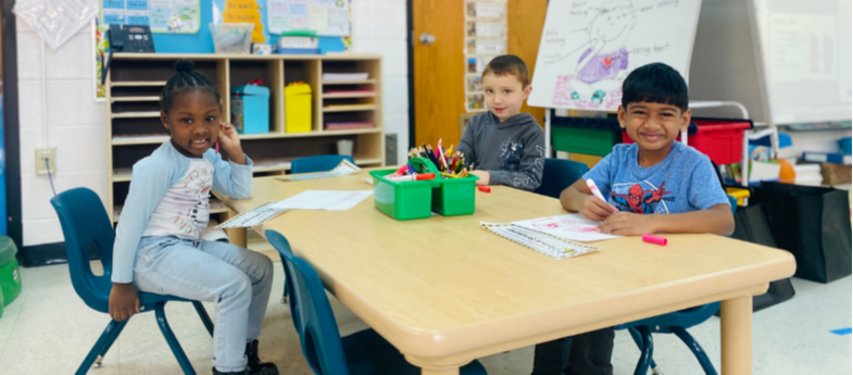 4k teacher and students sitting at desk