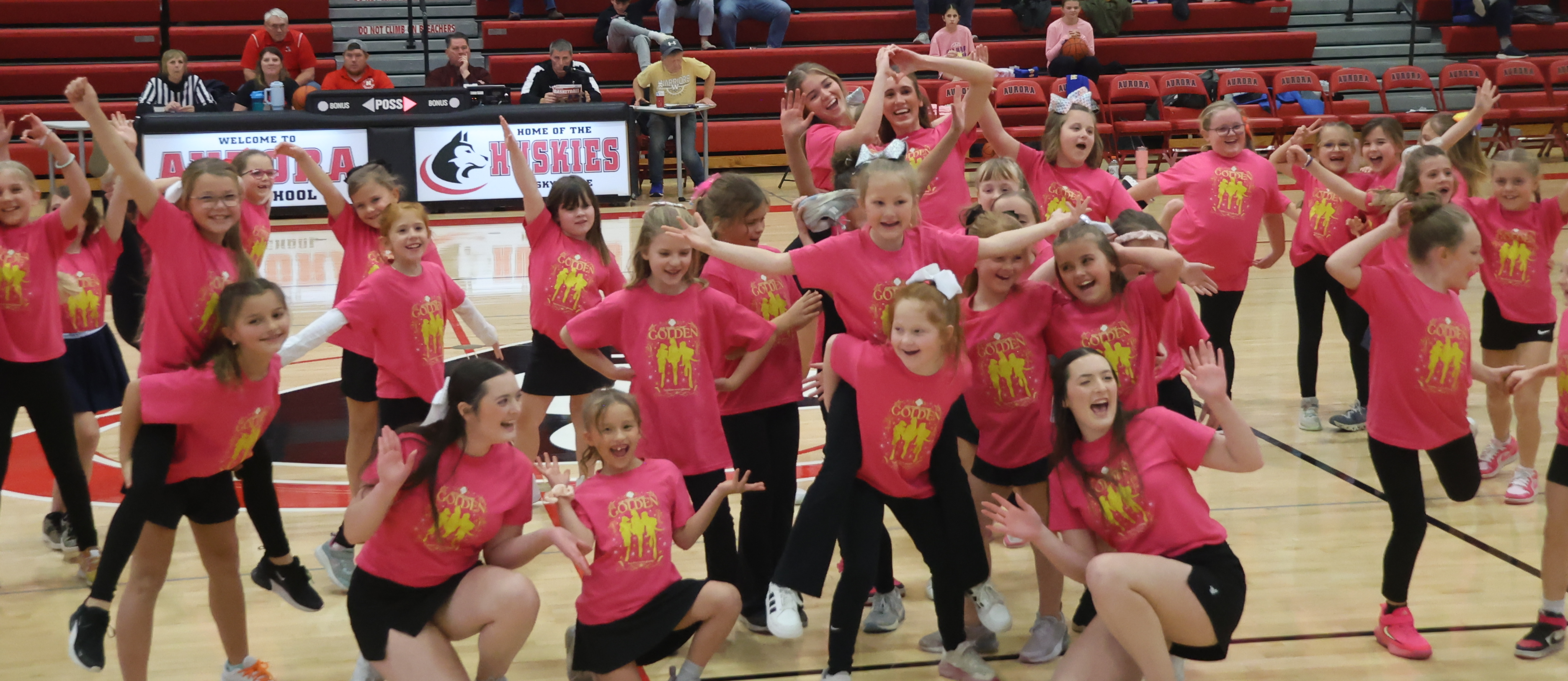 Elementary girls and High school cheerleaders perform at halftime