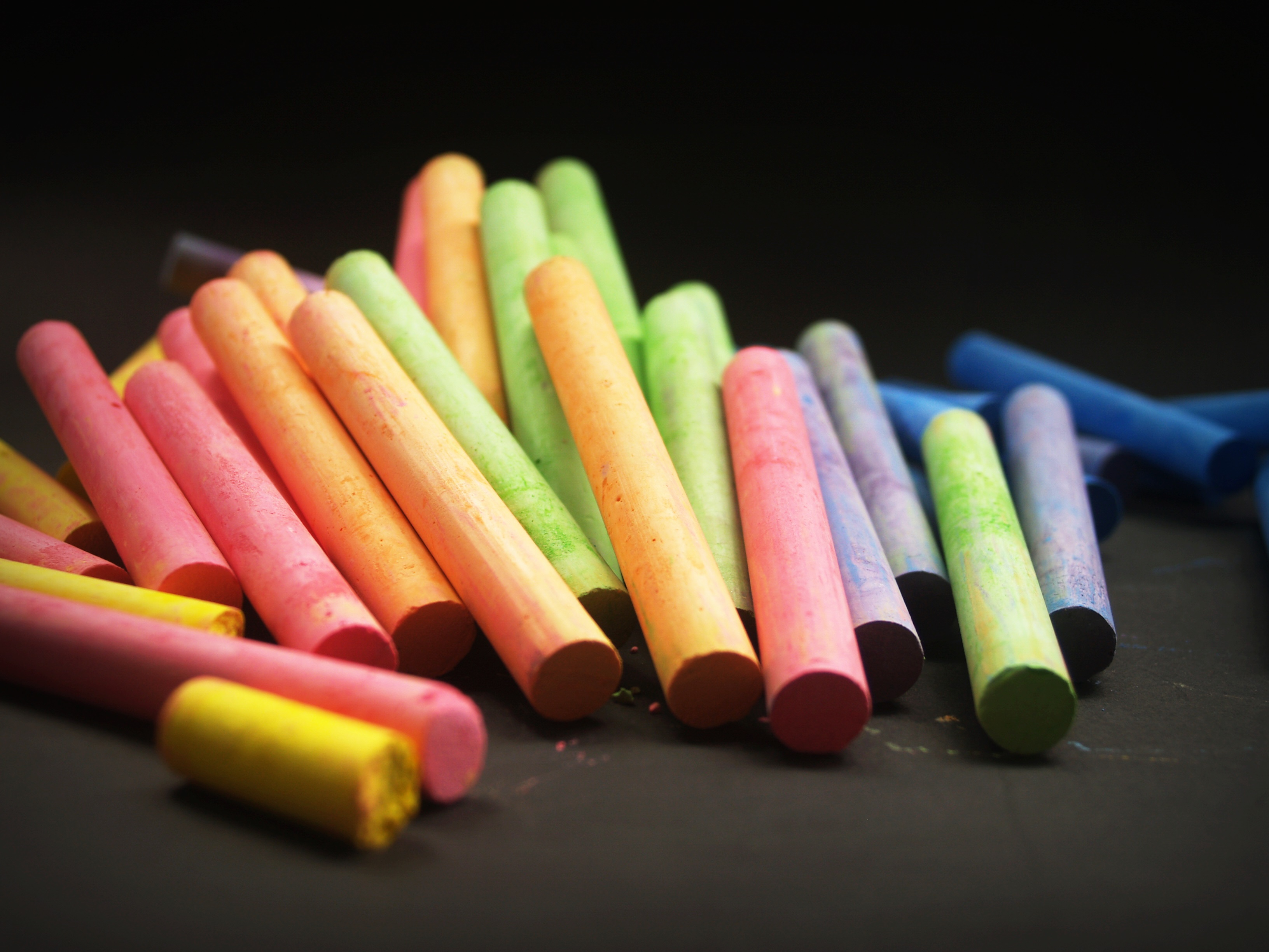 A pile of colorful chalk on a black background