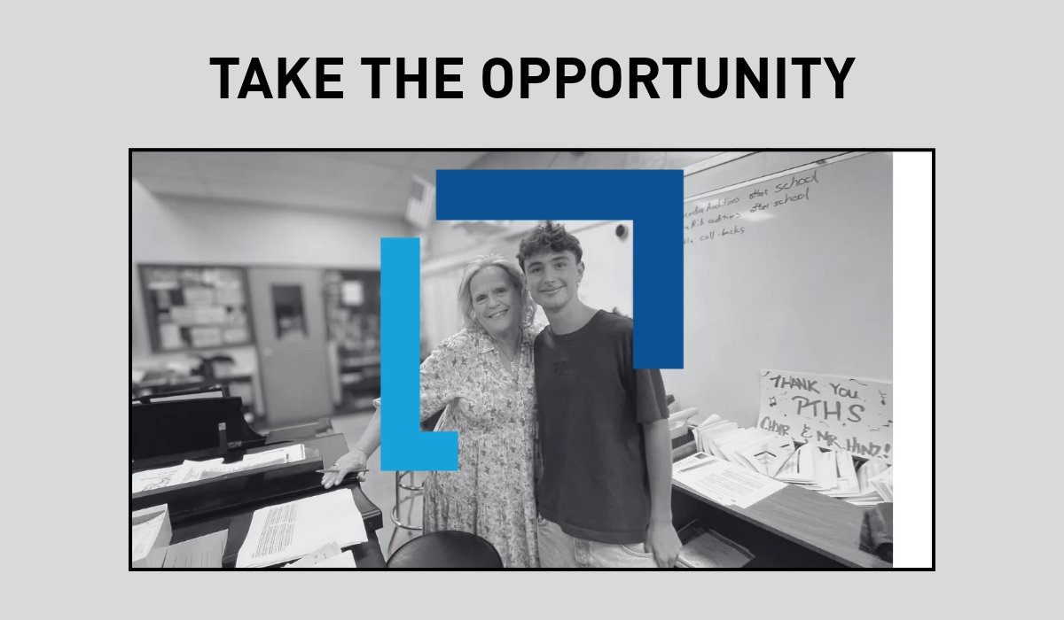 Black and white photo of a man and woman standing together in a classroom.