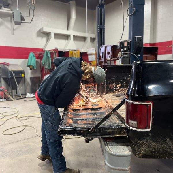 Student repairing car