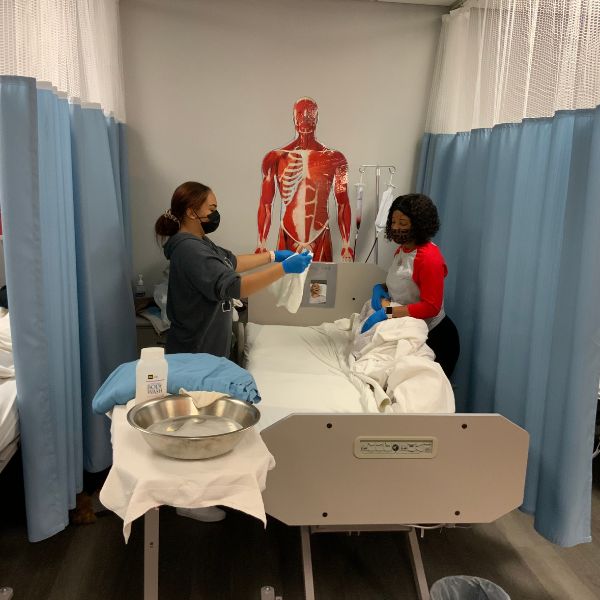 Students preparing a medical bed