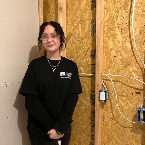 Construction technology student inside a bathroom that she built