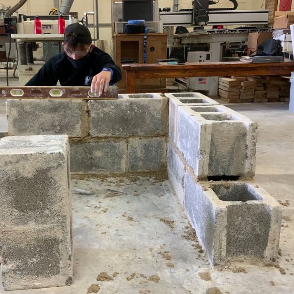 Student laying block