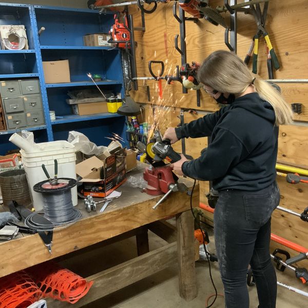 Student working on outdoor tools
