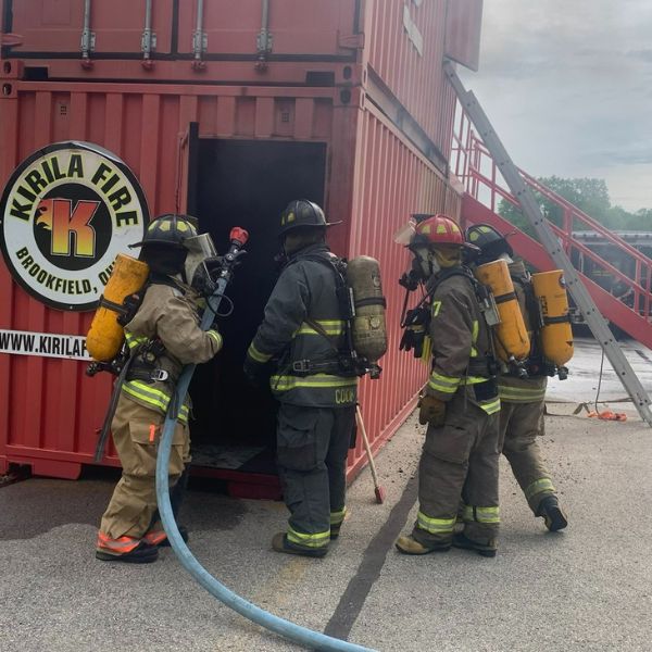 Students entering a burn container