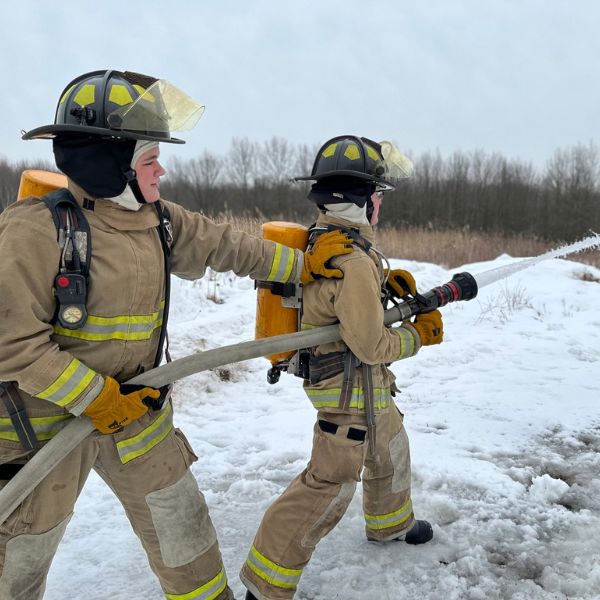 Students running fire hose