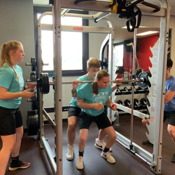 Students working with weight equipment