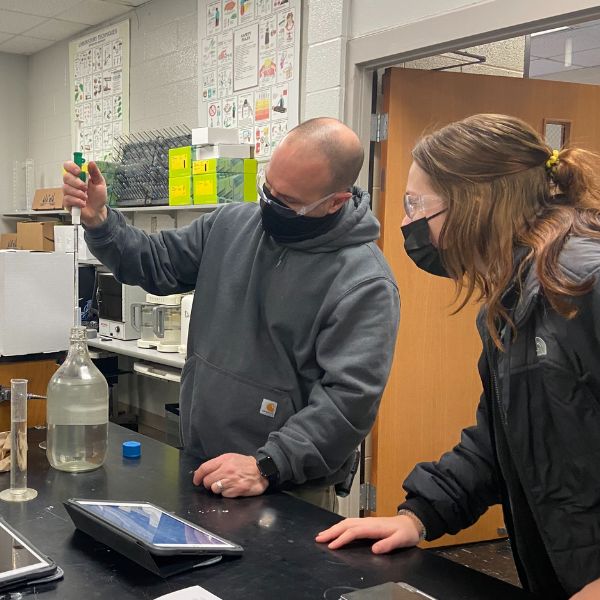 Student and instructor working on biotech experiment 