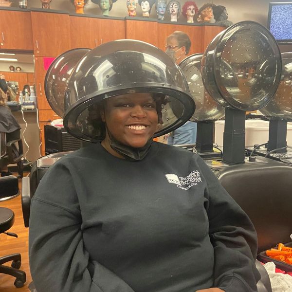 Student under hair dryer