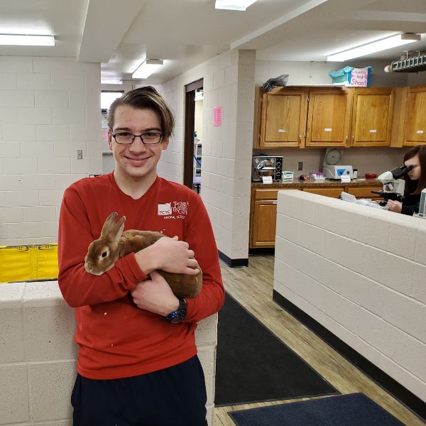 Student holding rabbit