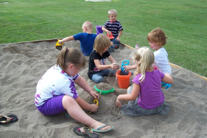 Students playing in the sandbox