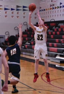 photo of high school men's basketball player shooting the ball during a game