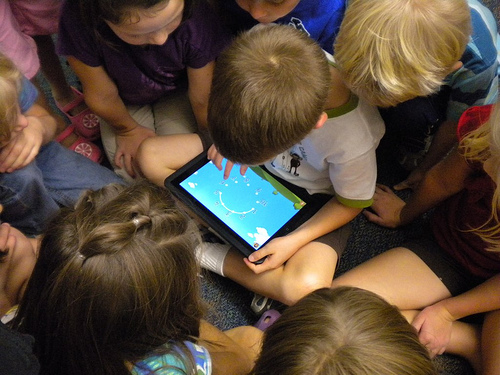 Kids gathered around an iPad