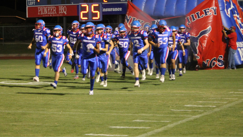 football players running onto field