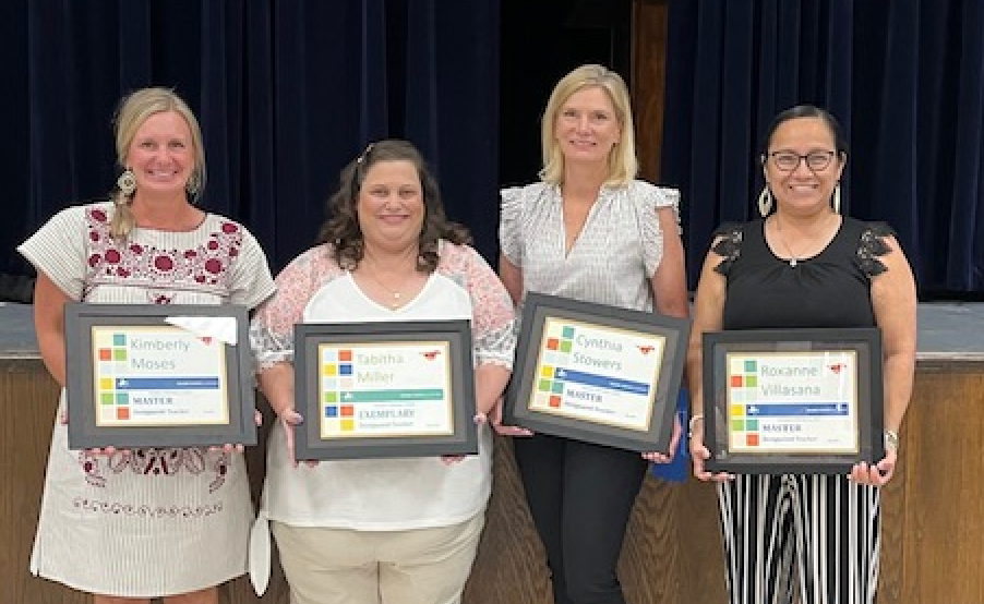 group of teachers holding awards
