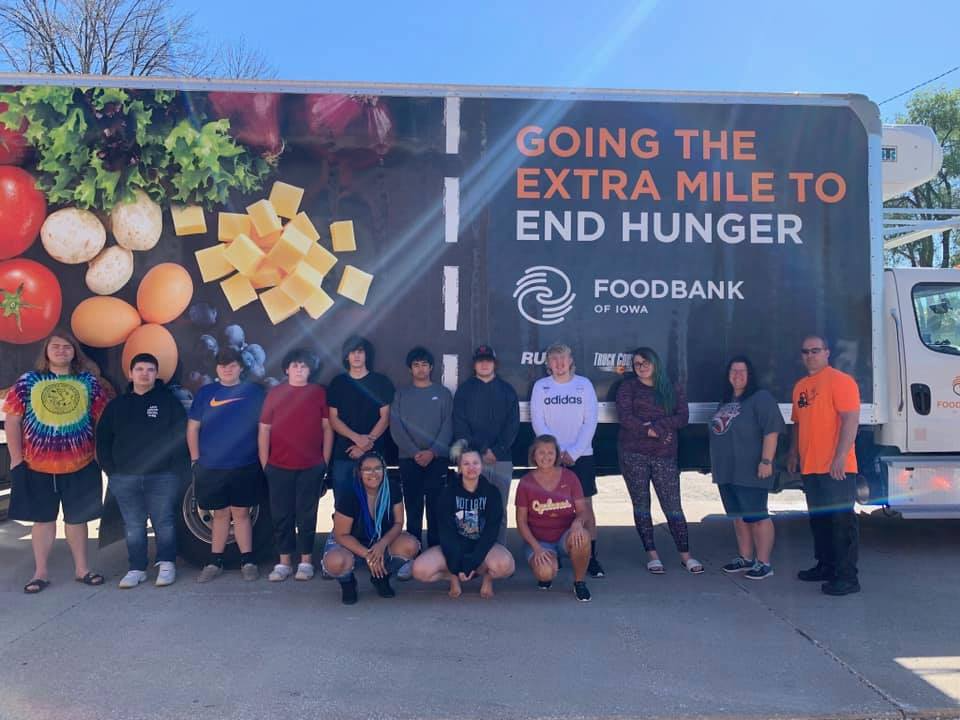 Students standing in front of foodbank semi truck
