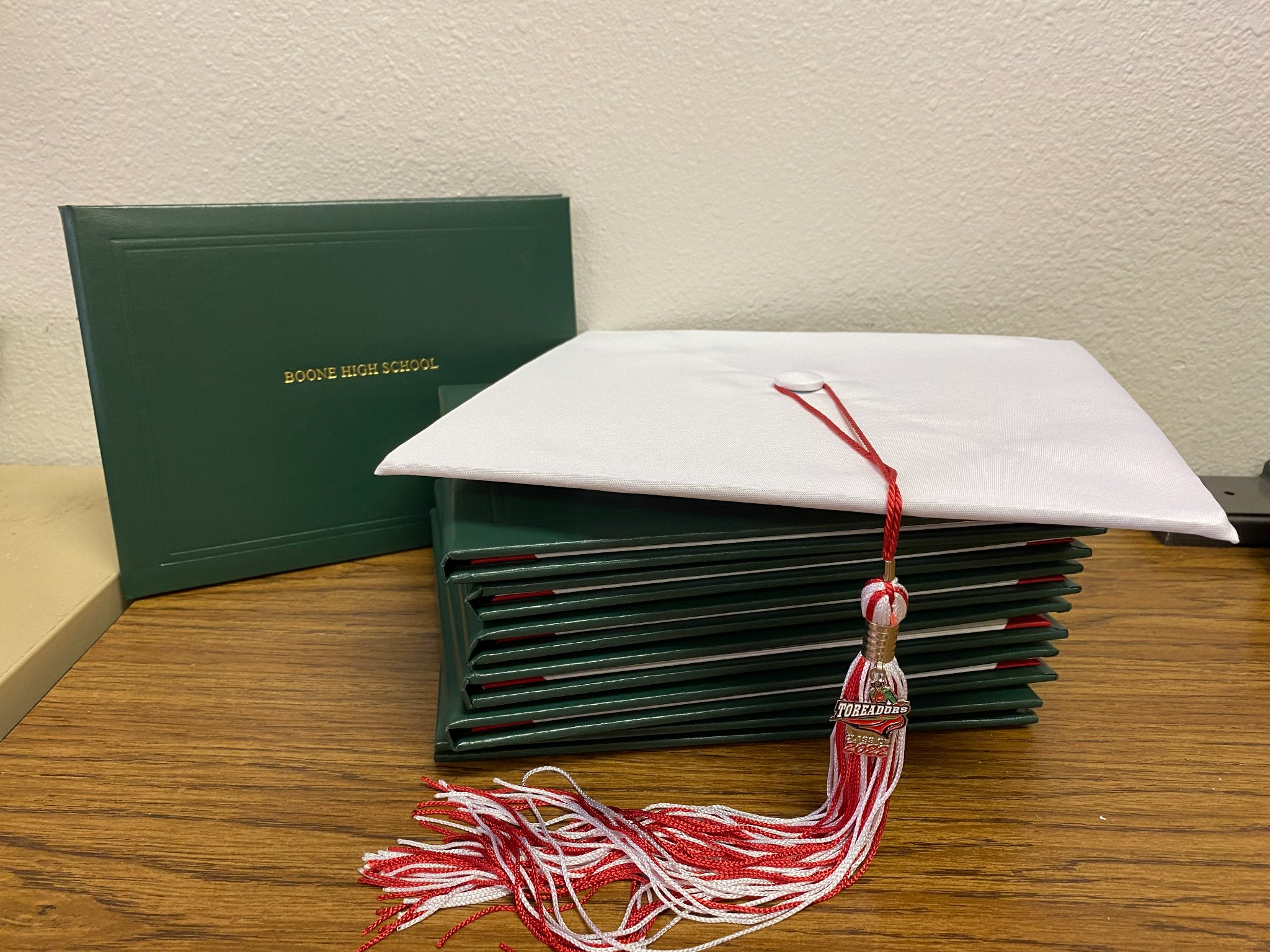 diploma book and graduation cap