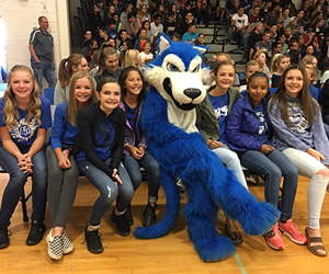 students pose with mascot