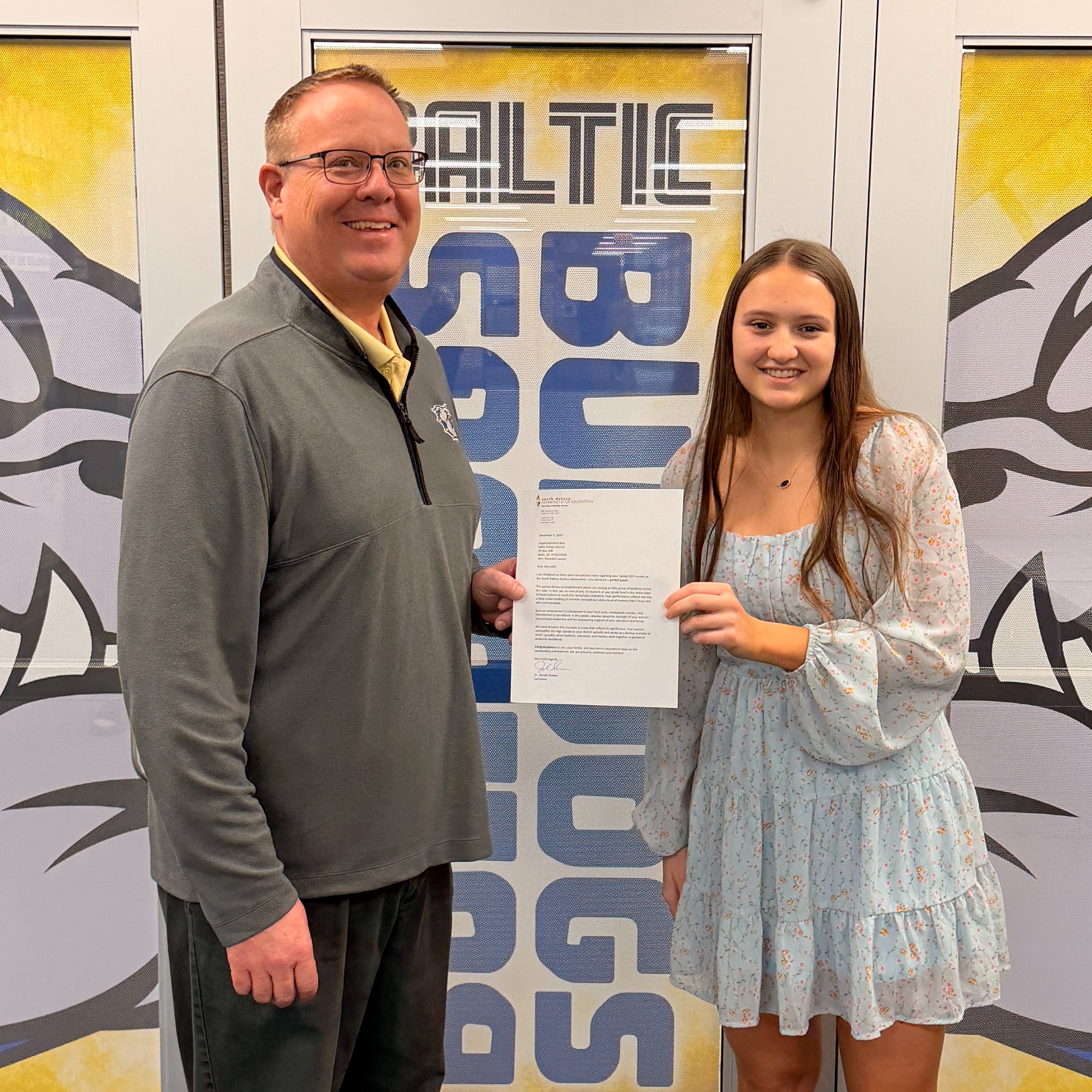 Meredith Larson and Dan Aaker holding a certificate