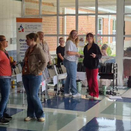 Staff members prepare Chromebooks for distribution to families.