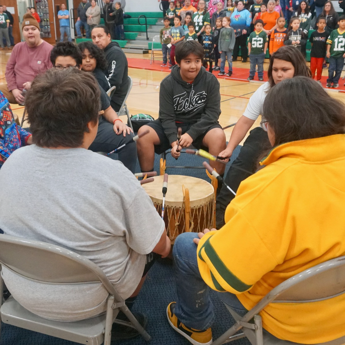 Young boys practice in drum circle together