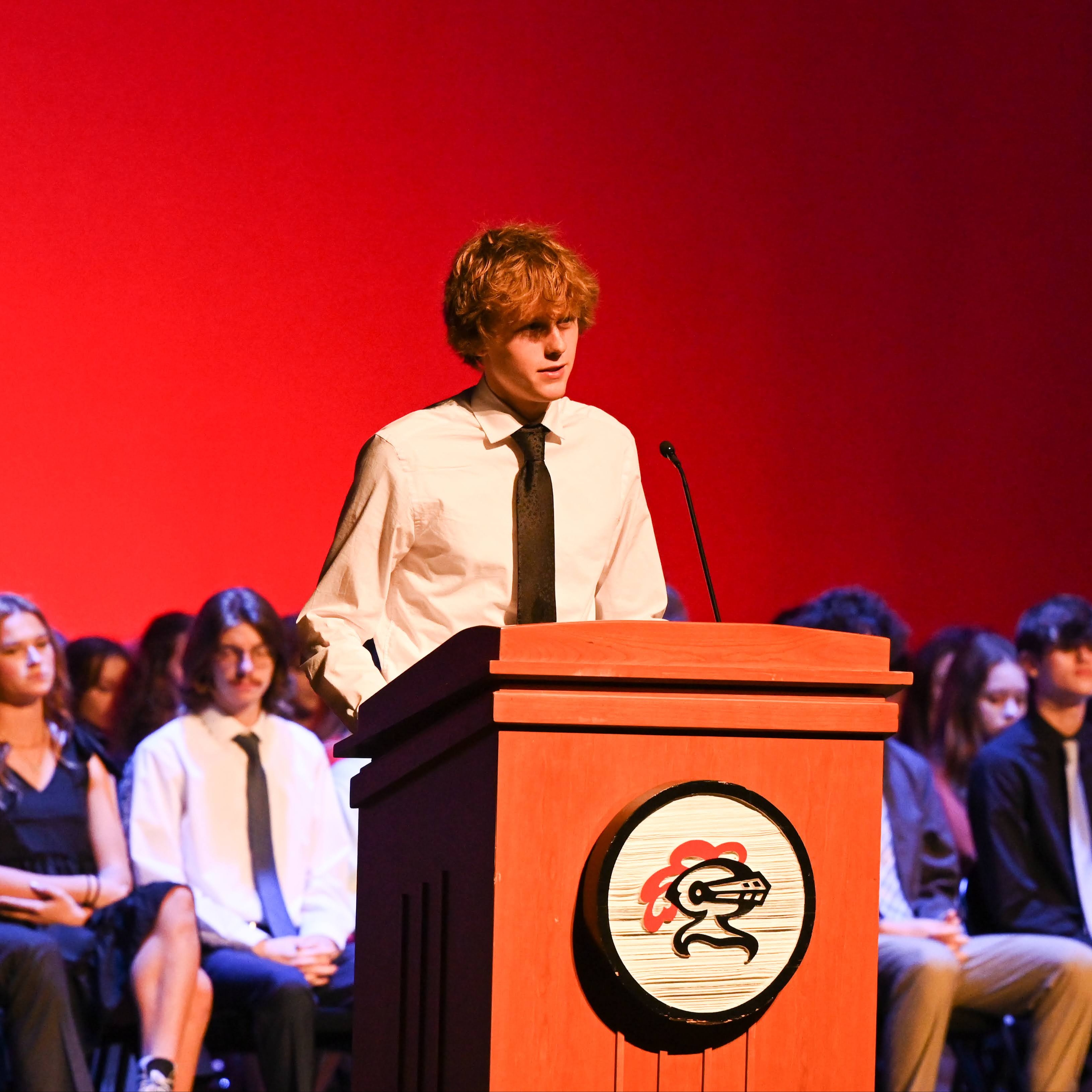 Student speaking at a podium