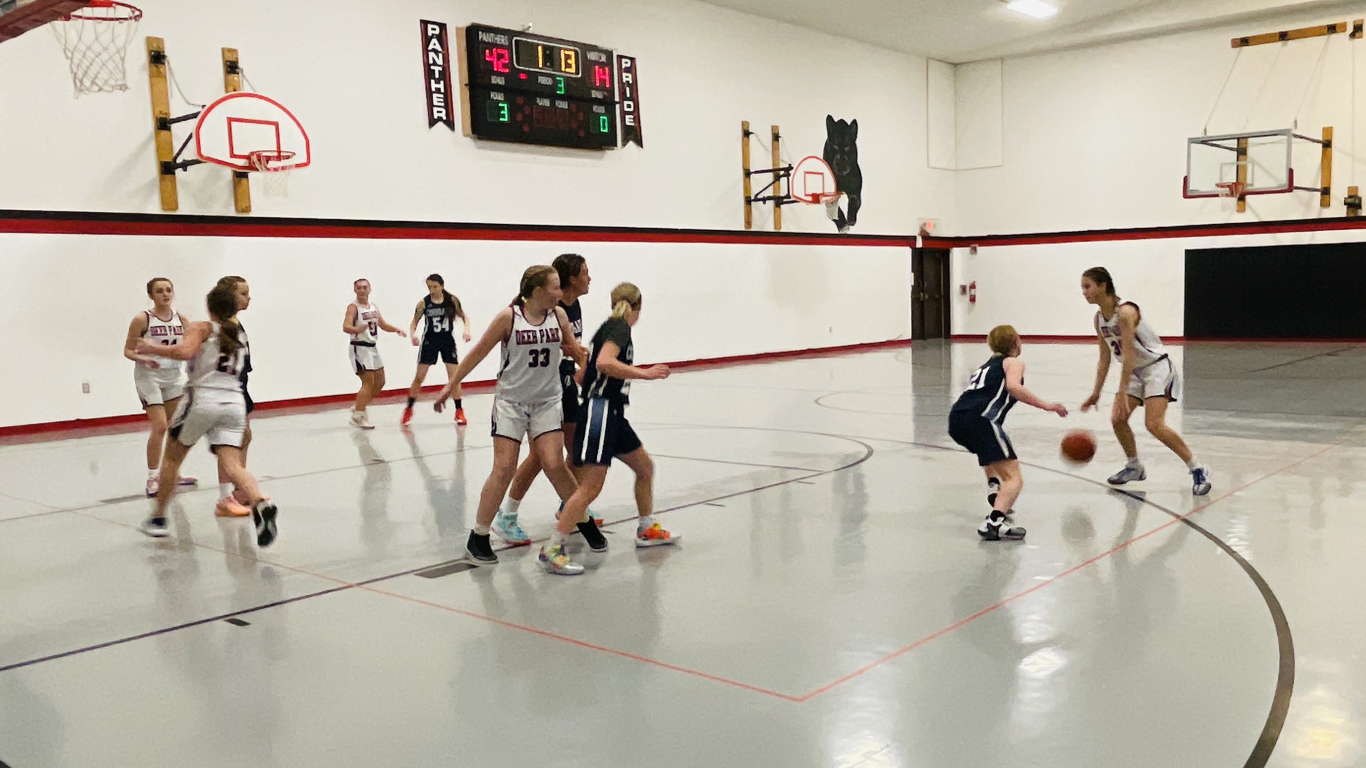 pre teen girls playing basketball
