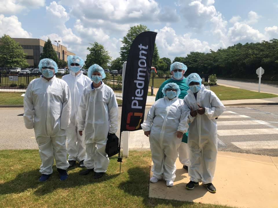 Project Search students in front of Piedmont flag